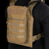 Person wearing the Condor Tidepool Hydration Carrier—a tan vest with zippered front pouch and MOLLE webbing—over a black long-sleeve shirt; perfect for bushcraft or range use.